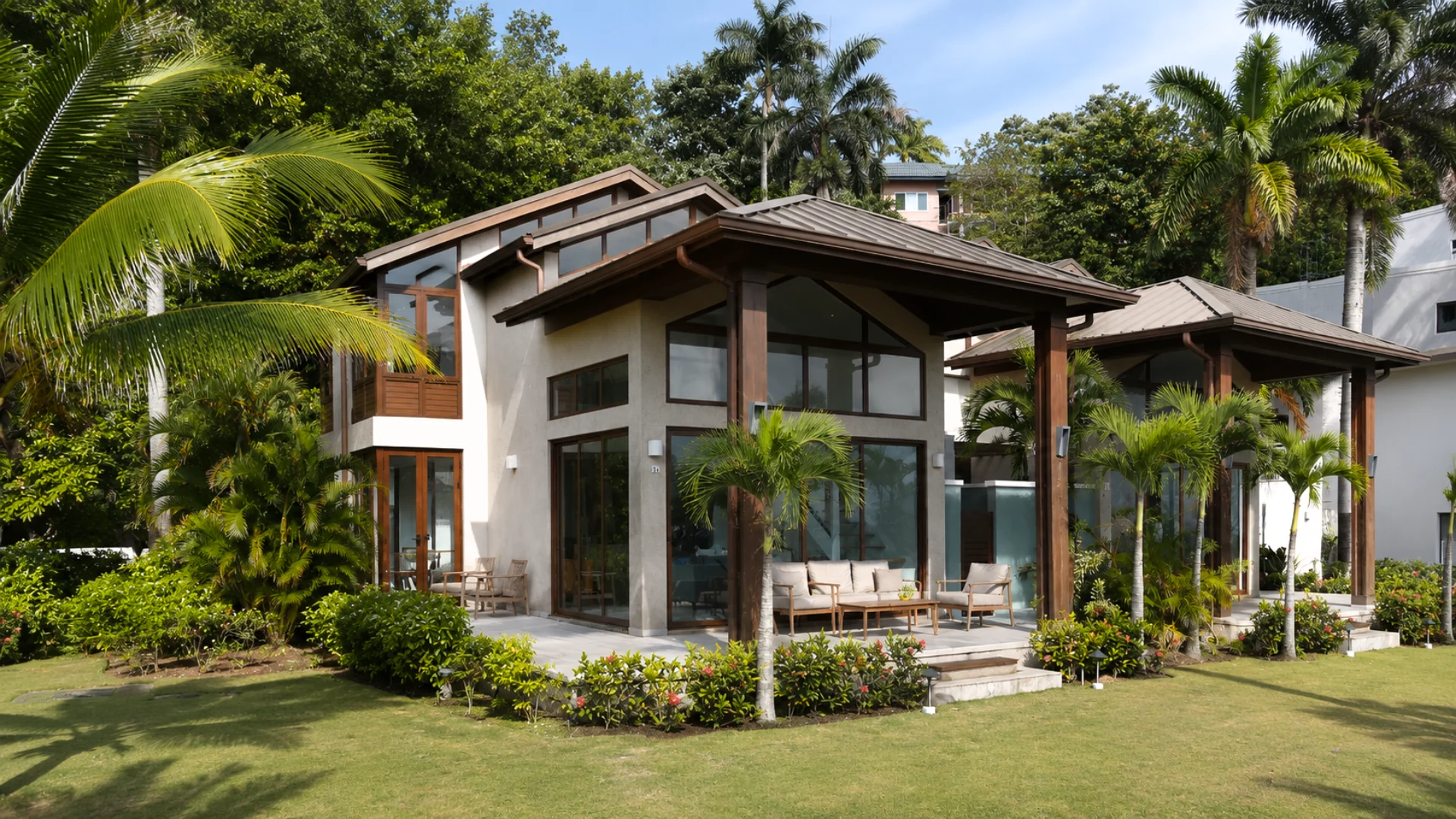 A Bessa pool villa with a shaded terrace and tropical garden