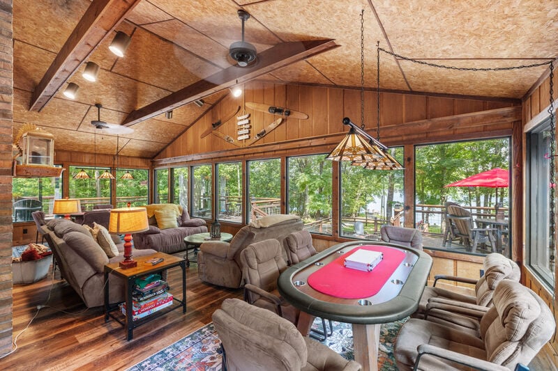 Screened porch with wood ceiling, seating and dining table